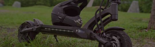An electric scooter with helmet placed on the deck
