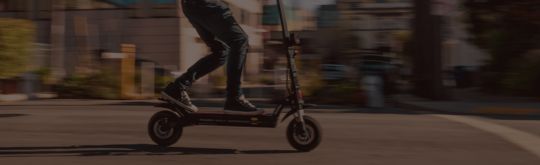 Person riding an escooter through town