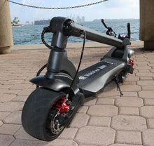 Load image into Gallery viewer, folded WideWheel PRO electric scooter by sea
