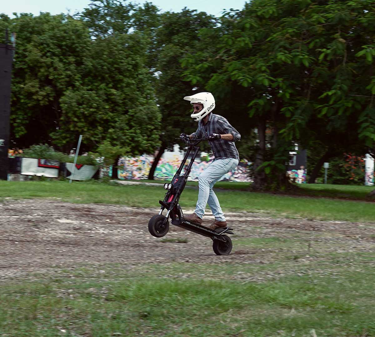 A racer in protective gear takes on an urban track on their electric scooter, demonstrating agility and speed in a cityscape setting for the Electric Scooter Racing Series Championship.