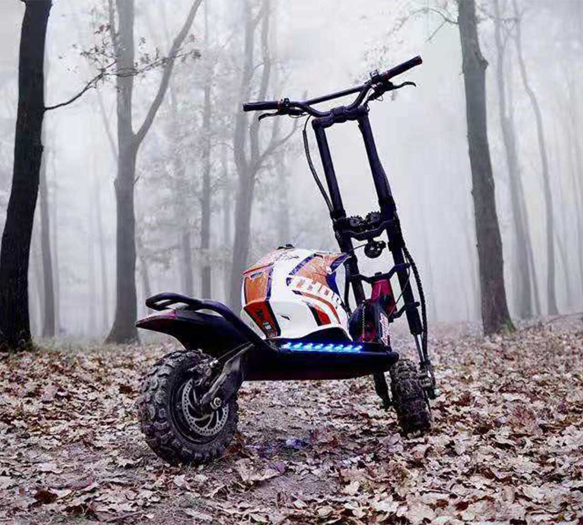 A high-performance electric scooter with chunky off-road tires is parked amidst a forest covered in fallen leaves, suggesting its use in electric scooter racing, a potential new adventurous sport.